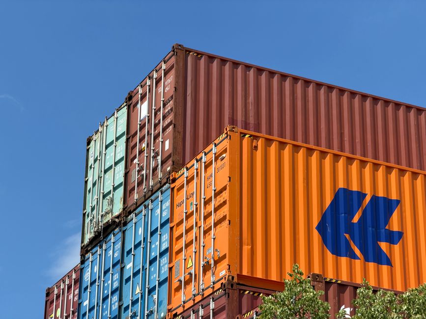 Exportação Brasileira. — Colorful shipping containers stacked in an outdoor storage area in Germany.